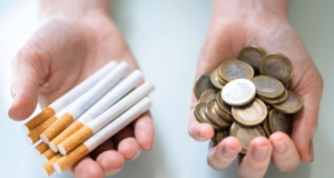 cigarettes in one hand money in other